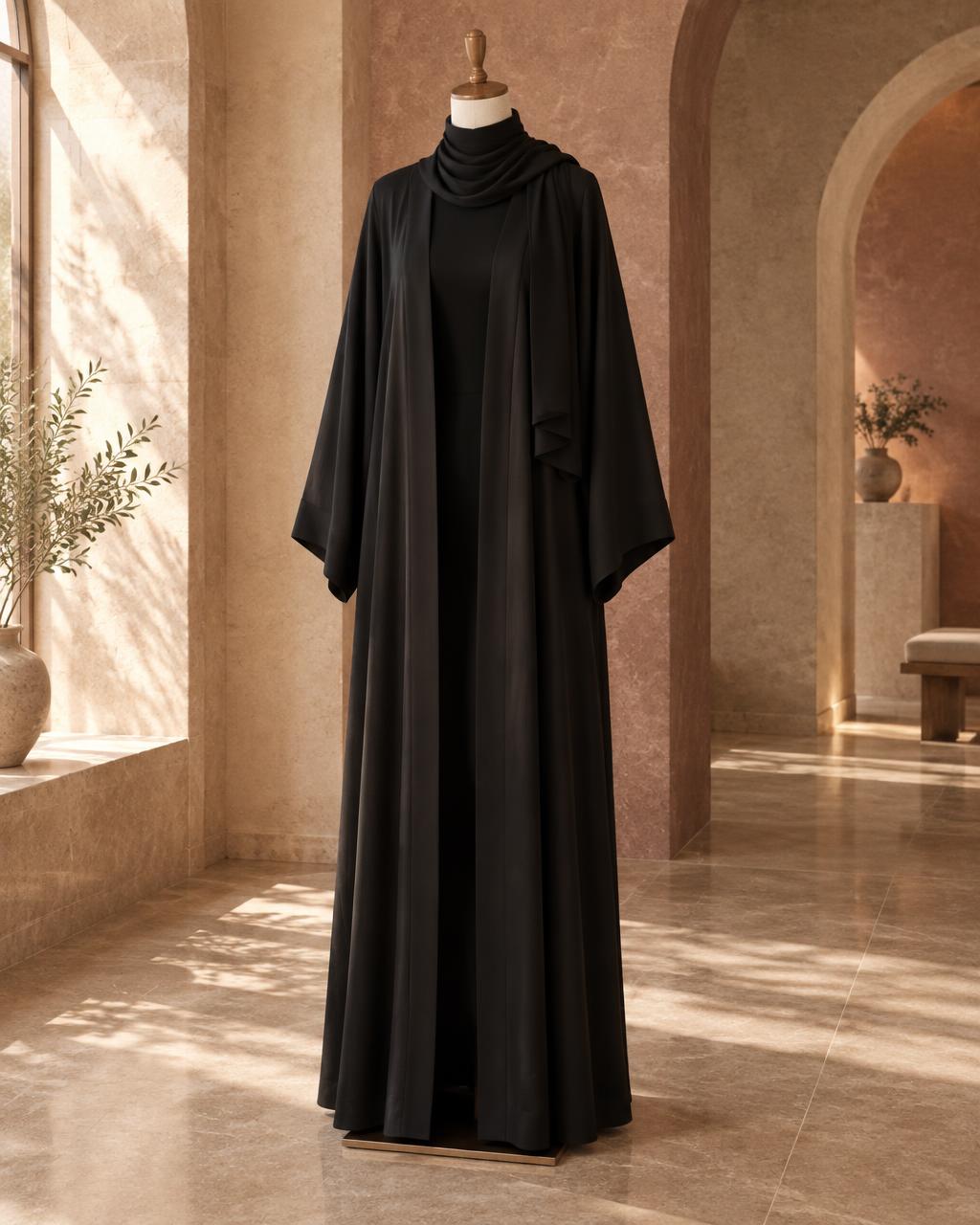 Black SALIHAAT open abaya on a mannequin in a sunlit arched interior